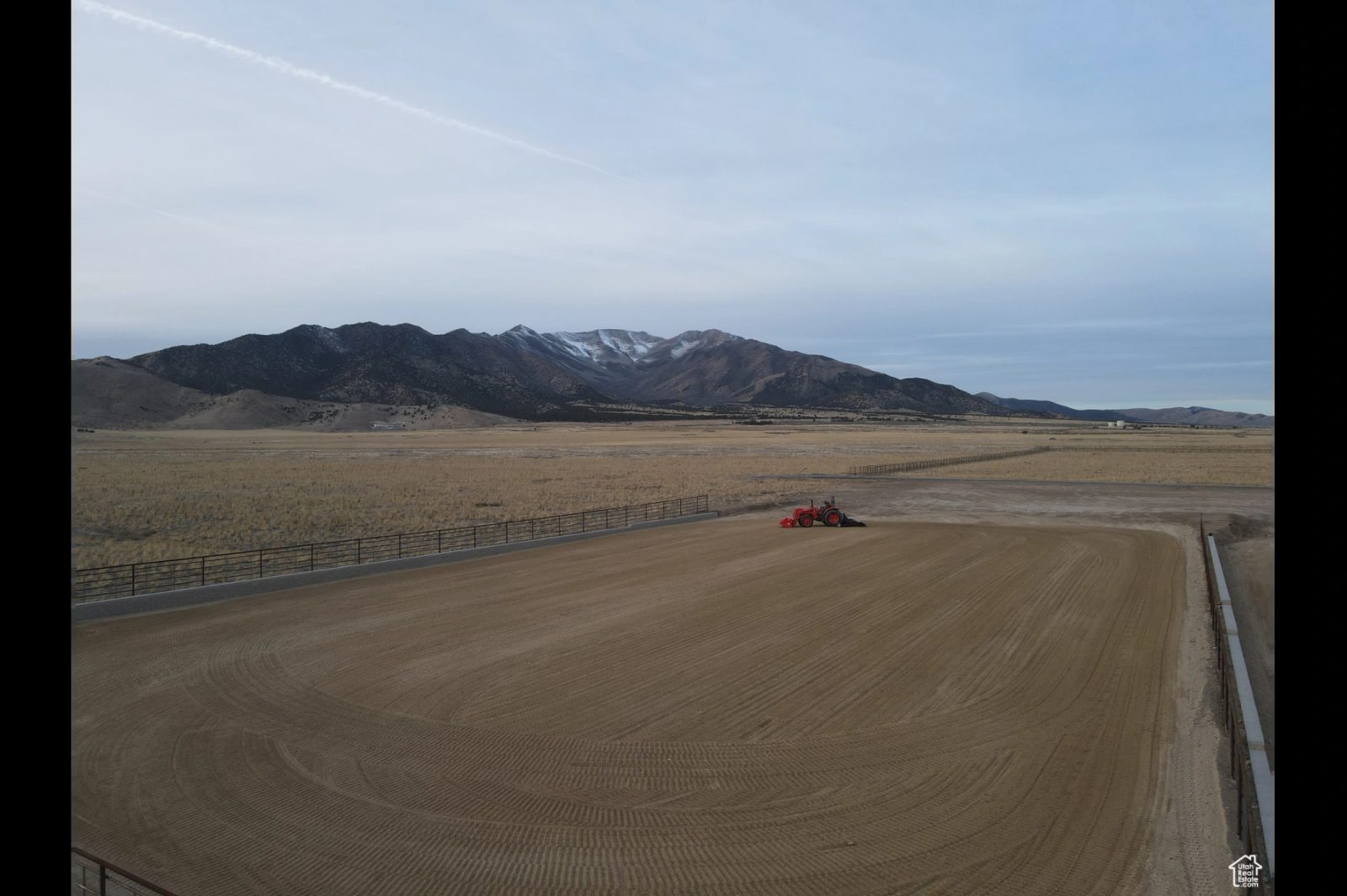 Arena and open land with mountain views